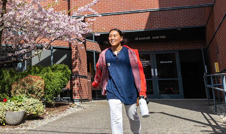 A student enjoys the sunshine outside McKenna Hall